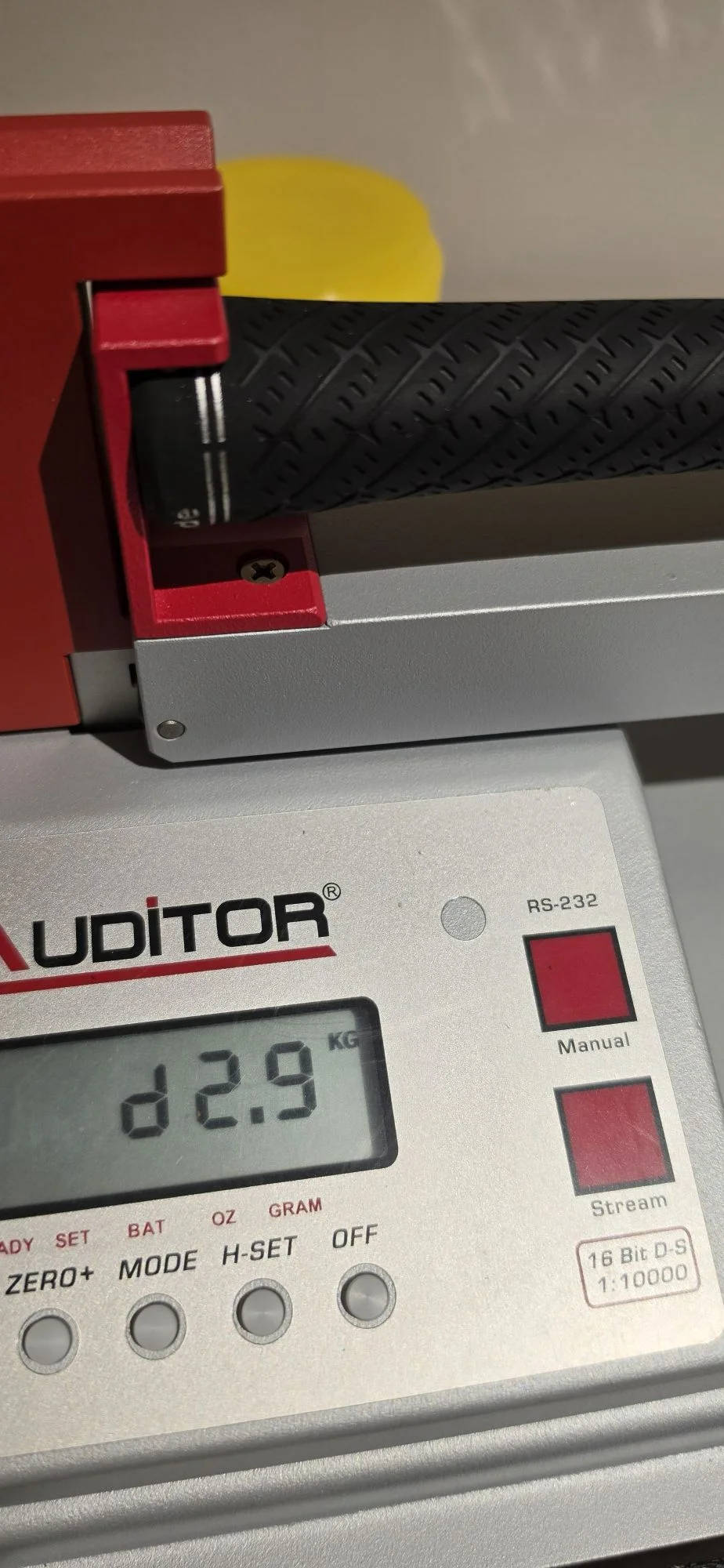 Swingweight being measured on a scale during golf club build verification